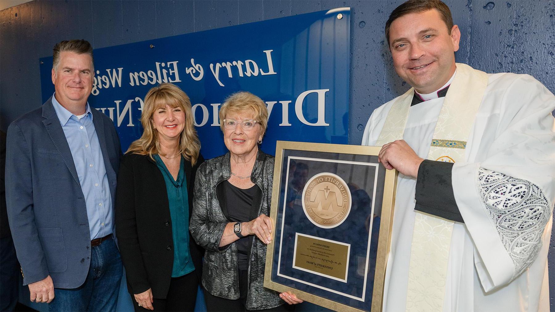 Weigum Nursing Dedication photo with the Weigums and Monsignor Shea